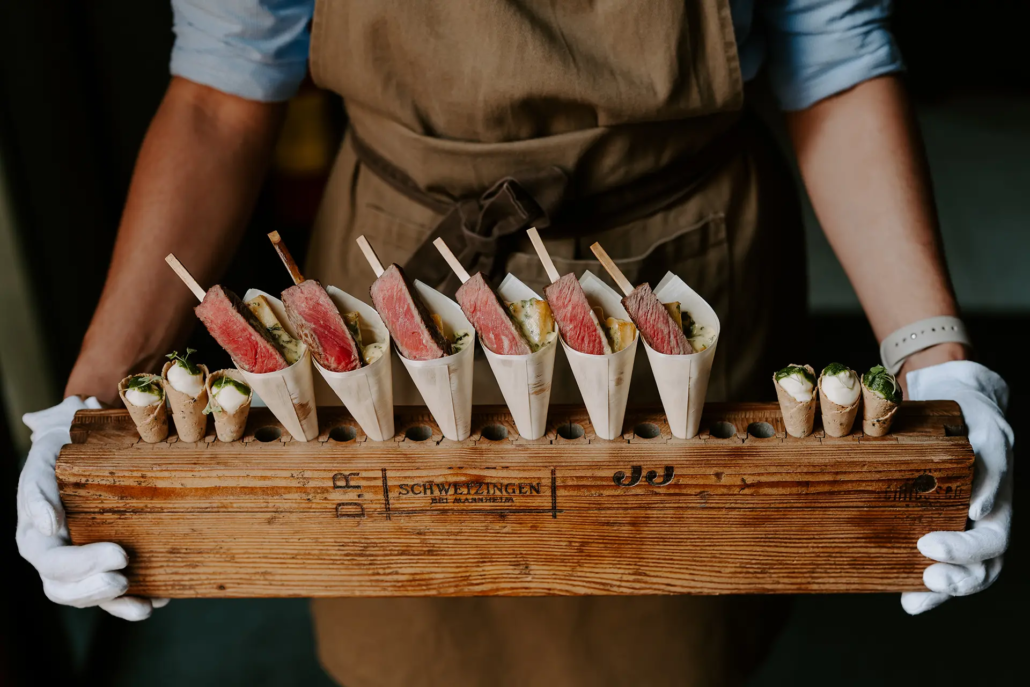 Waiting staff serving serloin steak canapes